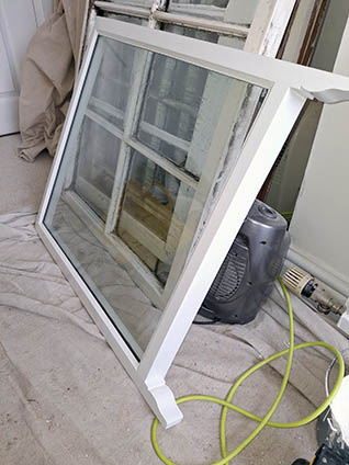 Restored timber sash window frame ready for installation in Warwickshire